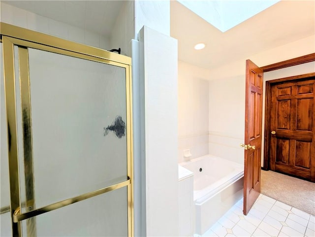 bathroom with a skylight and separate shower and tub