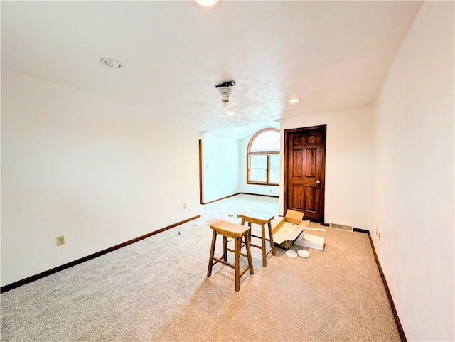 sitting room featuring light colored carpet