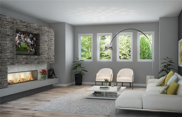 living room with a stone fireplace and light wood-type flooring