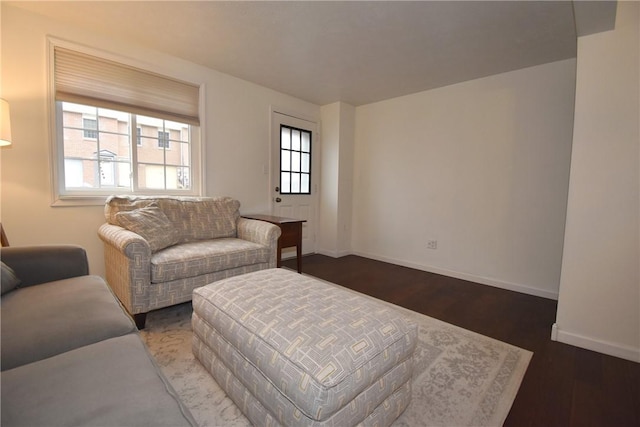 living room featuring plenty of natural light and dark hardwood / wood-style flooring