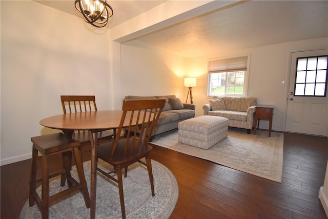 dining room featuring a notable chandelier and dark wood-type flooring