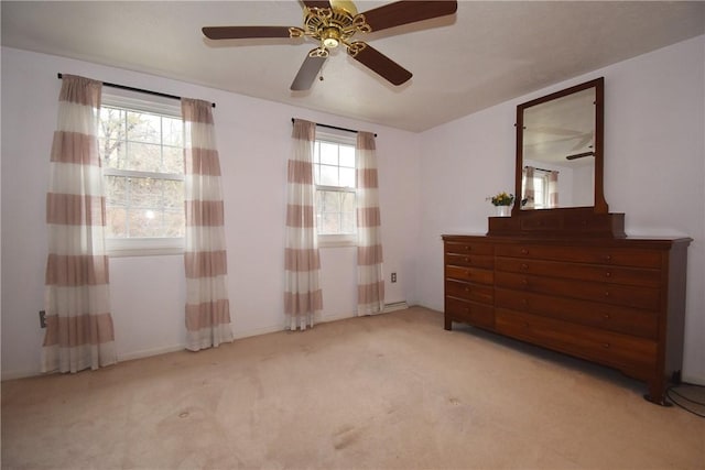 unfurnished bedroom featuring light carpet and ceiling fan