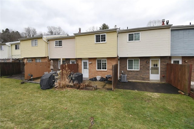 back of house featuring a yard, central AC, and a patio area