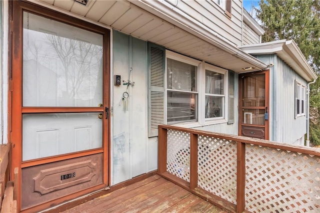 view of exterior entry featuring a wooden deck