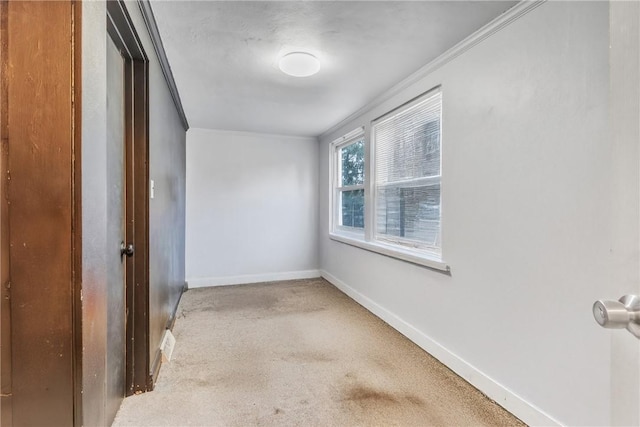 unfurnished room with crown molding and carpet flooring