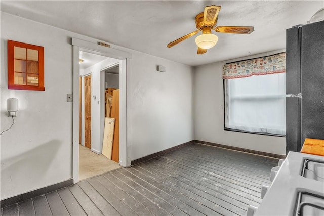 interior space with ceiling fan and dark hardwood / wood-style floors