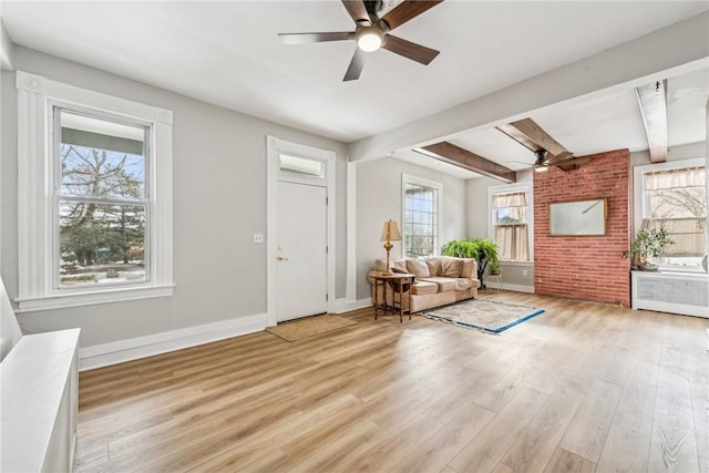 unfurnished room featuring a ceiling fan, light wood finished floors, radiator heating unit, baseboards, and beamed ceiling