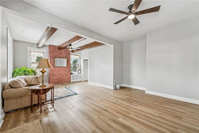 living room with baseboards, wood finished floors, and a ceiling fan
