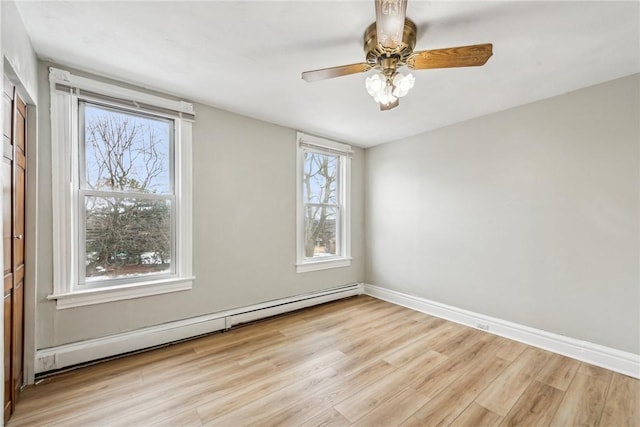 unfurnished room with baseboards, ceiling fan, wood finished floors, and baseboard heating