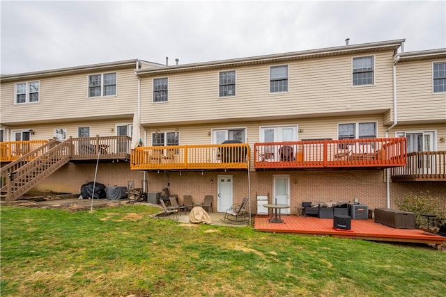 rear view of property featuring cooling unit, a yard, and a deck