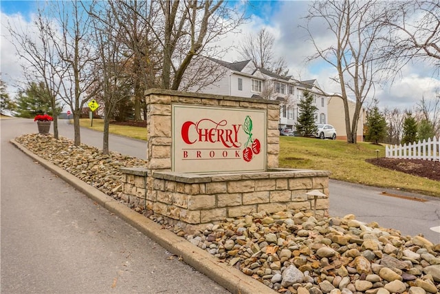 community / neighborhood sign with a yard