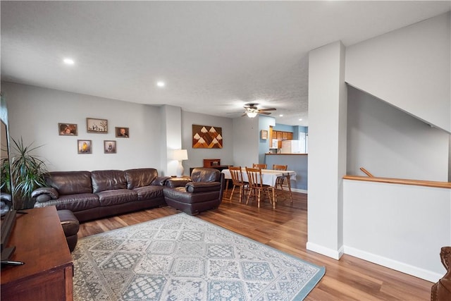 living room featuring hardwood / wood-style flooring and ceiling fan