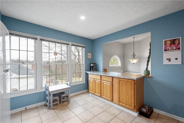 interior space featuring hanging light fixtures, a textured ceiling, and light tile patterned flooring