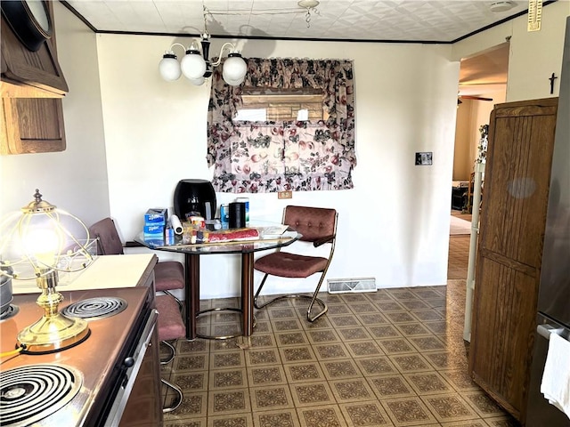 dining room with an inviting chandelier and ornamental molding