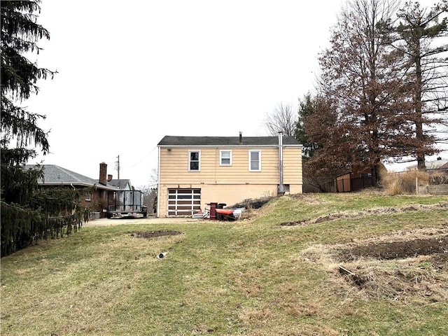 back of house with a lawn