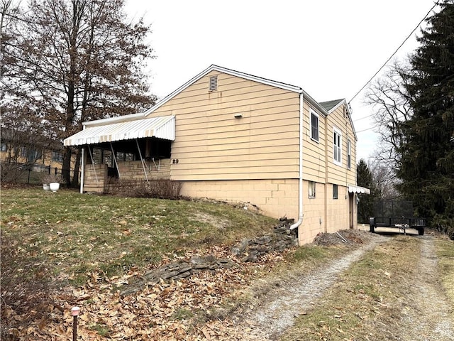 view of side of property with a lawn