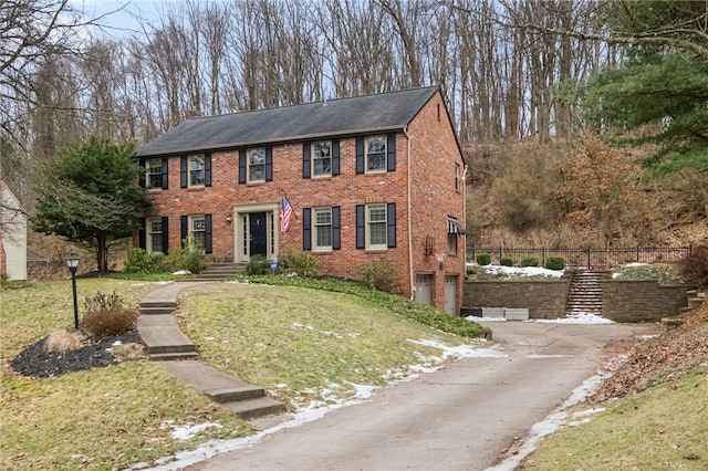 view of front of property featuring a garage and a front lawn