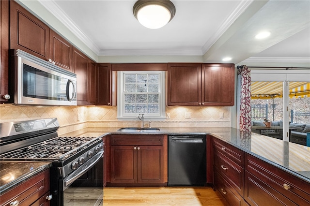 kitchen featuring dishwasher, plenty of natural light, sink, and range with gas stovetop