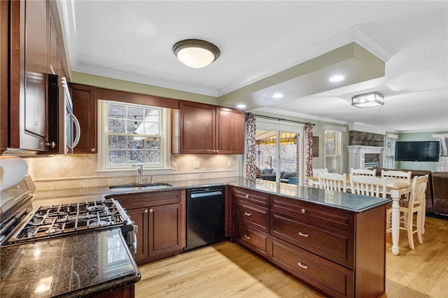 kitchen featuring crown molding, dark stone counters, black dishwasher, and kitchen peninsula