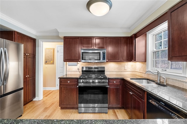 kitchen with sink, decorative backsplash, light hardwood / wood-style floors, stainless steel appliances, and crown molding