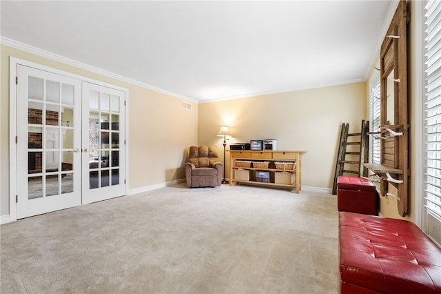 sitting room with french doors, ornamental molding, and carpet