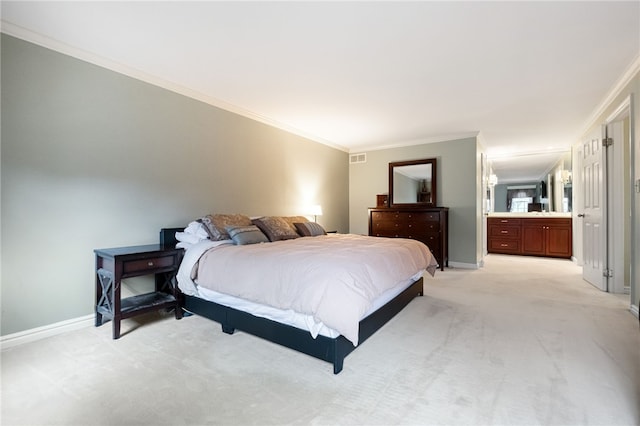 carpeted bedroom featuring crown molding and ensuite bathroom