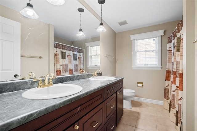 bathroom with tile patterned flooring, vanity, and toilet