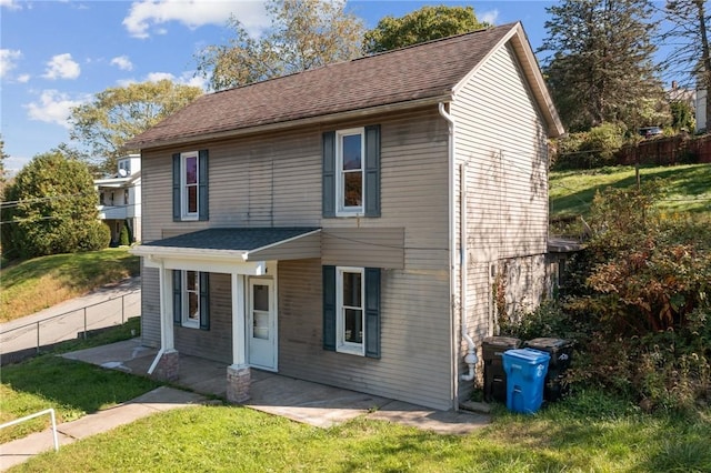 view of property with a front lawn and a patio