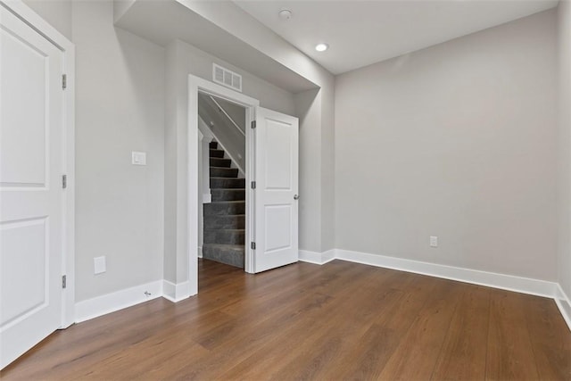 empty room with dark hardwood / wood-style flooring