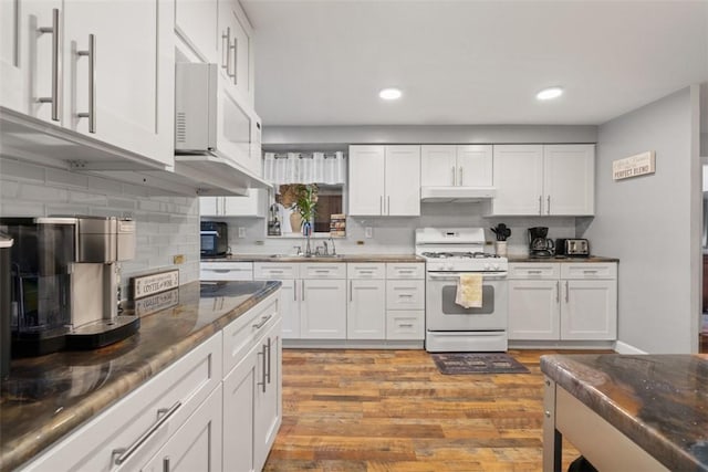 kitchen featuring white cabinetry, sink, and white appliances