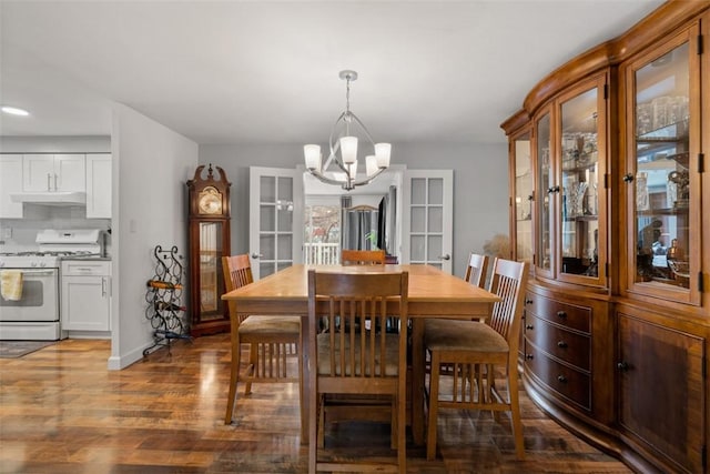 dining room featuring hardwood / wood-style flooring and a notable chandelier