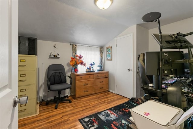 office space with wood-type flooring and vaulted ceiling