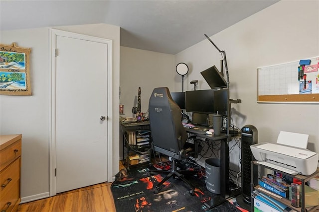 office with lofted ceiling and light hardwood / wood-style flooring