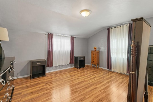 interior space with light hardwood / wood-style flooring and vaulted ceiling