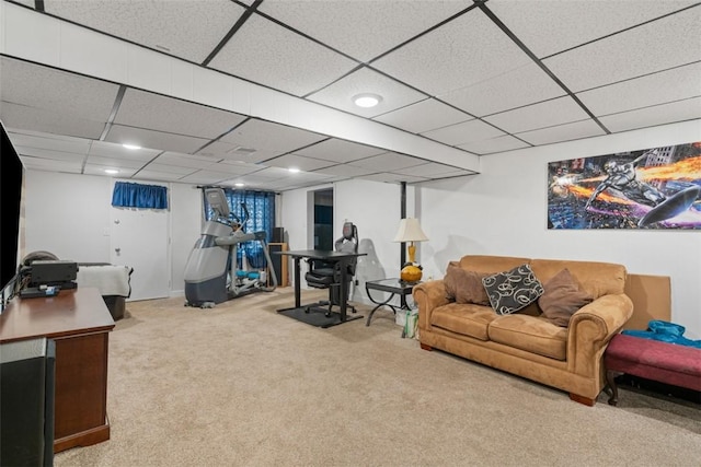 living room with a paneled ceiling and light carpet