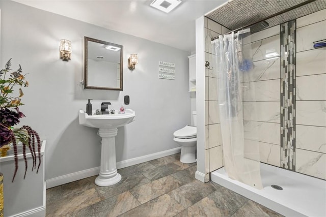 bathroom with toilet and a shower with shower curtain