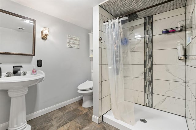 bathroom with sink, toilet, and walk in shower