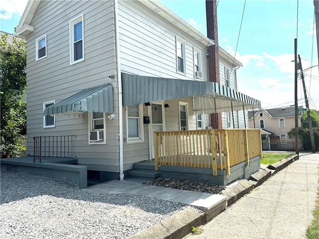 view of side of property with cooling unit and a porch