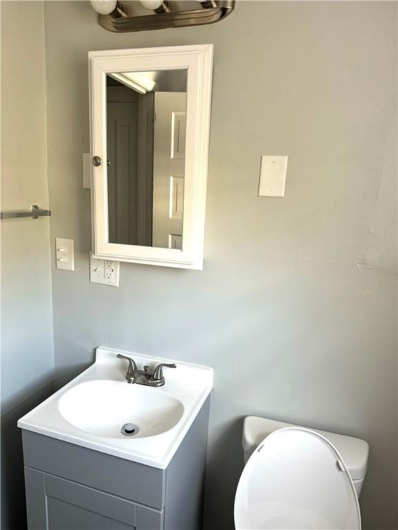 bathroom featuring vanity and toilet