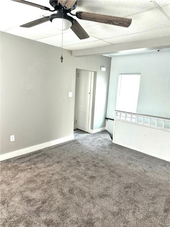 unfurnished room featuring ceiling fan and carpet floors