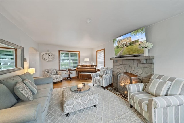 living room with a fireplace and light hardwood / wood-style flooring