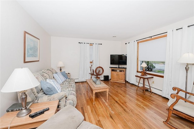 living room featuring a baseboard heating unit and light wood-type flooring