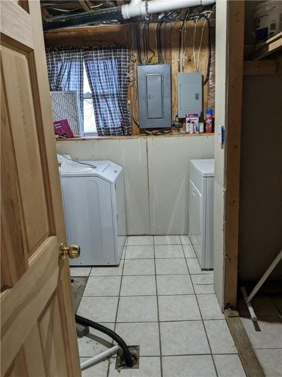 laundry area featuring light tile patterned flooring, electric panel, and washer and clothes dryer