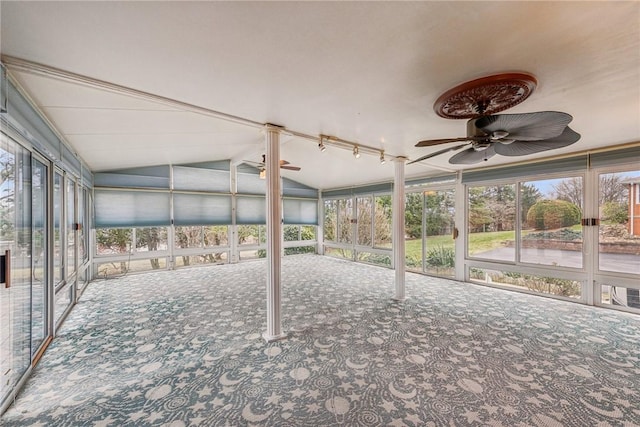 unfurnished sunroom with ceiling fan, lofted ceiling, and plenty of natural light