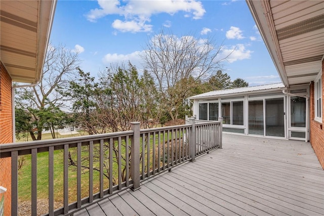 wooden terrace featuring a sunroom