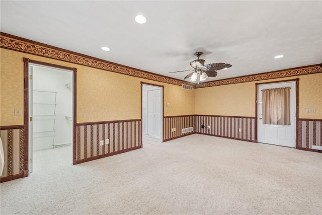 empty room featuring ceiling fan and carpet