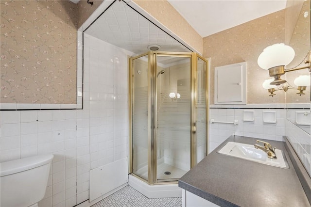 bathroom featuring vanity, tile walls, and an enclosed shower