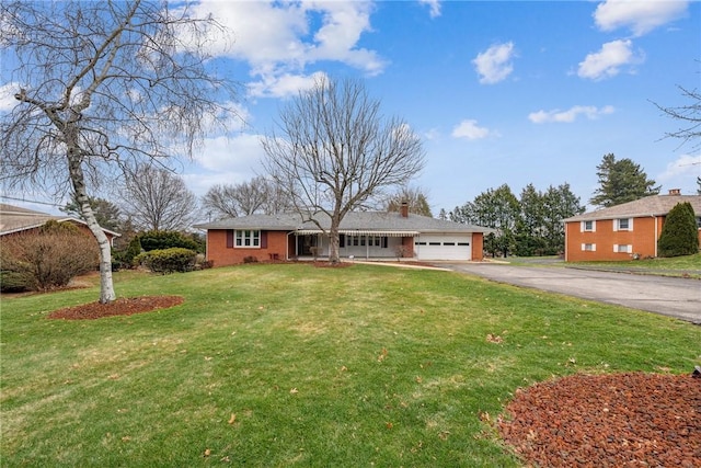 single story home with a garage and a front lawn