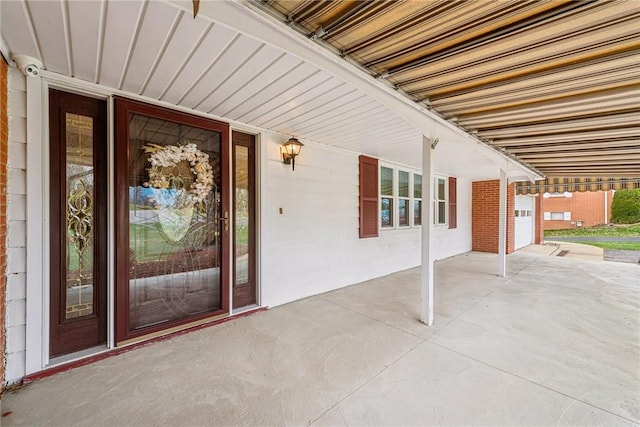 property entrance featuring a patio area