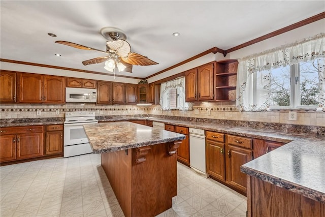 kitchen with white appliances, ornamental molding, a center island, and backsplash